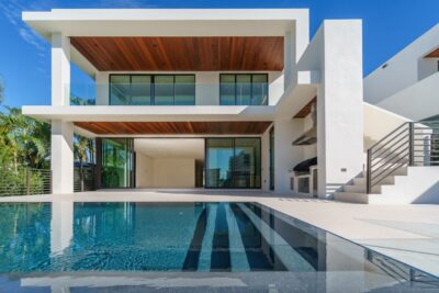 A luxury white modern-style house with a pool