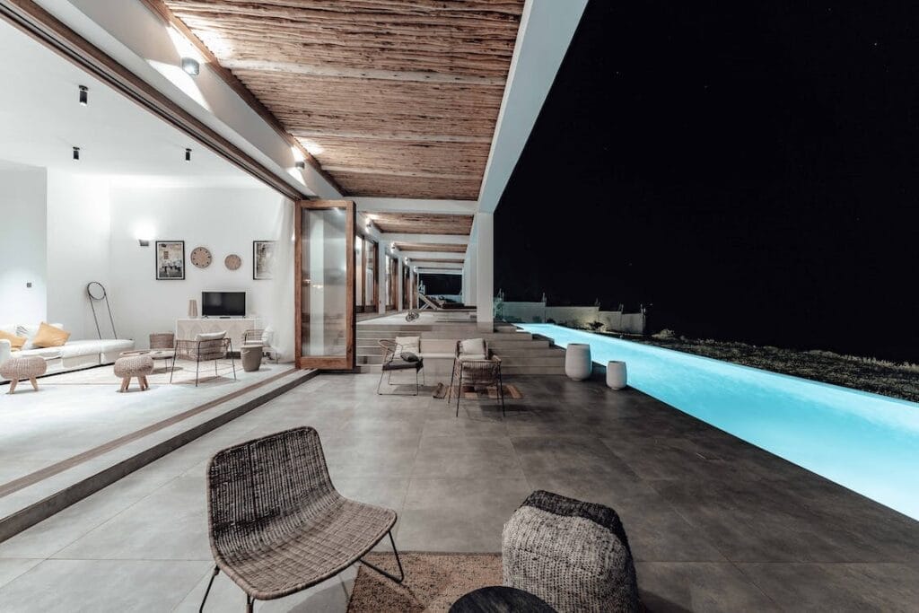 brown wicker chair near swimming pool during nighttime